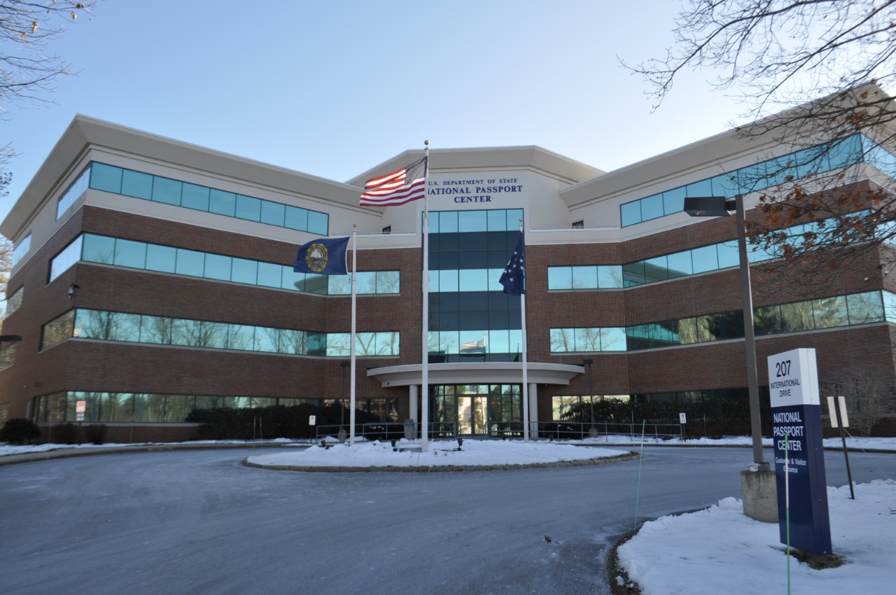 Exterior of National Passport Center. It is a 4-story office building.