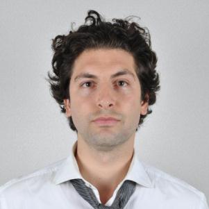 Photo of a man against an off-white background.