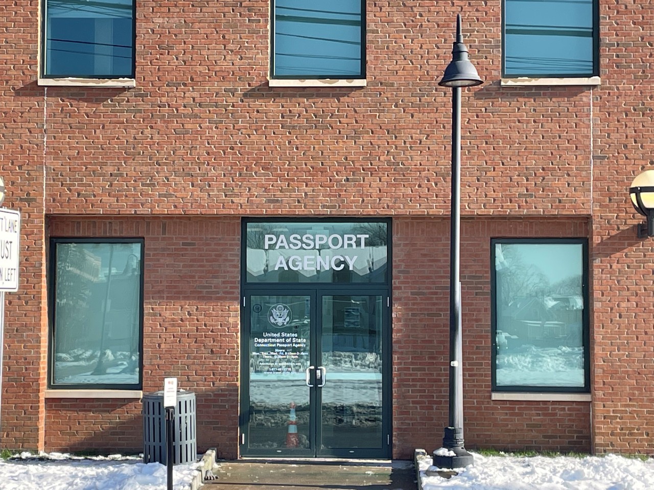 Front entrance of the Connecticut Passport Agency in a brick building.